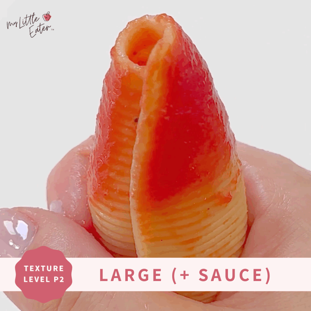 Large shell pasta covered in sauce, being held in a palmar grasp.