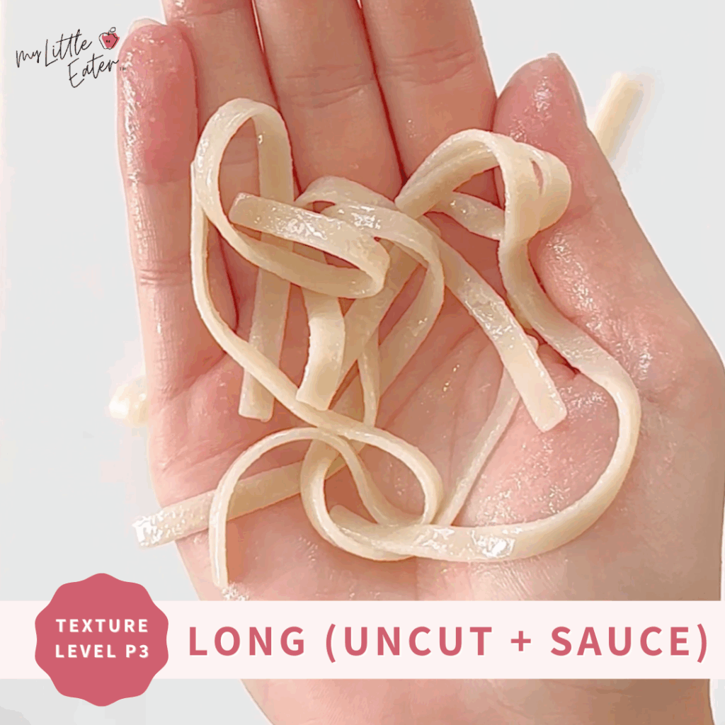 Long, uncut spaghetti noodles in someone's hand.
