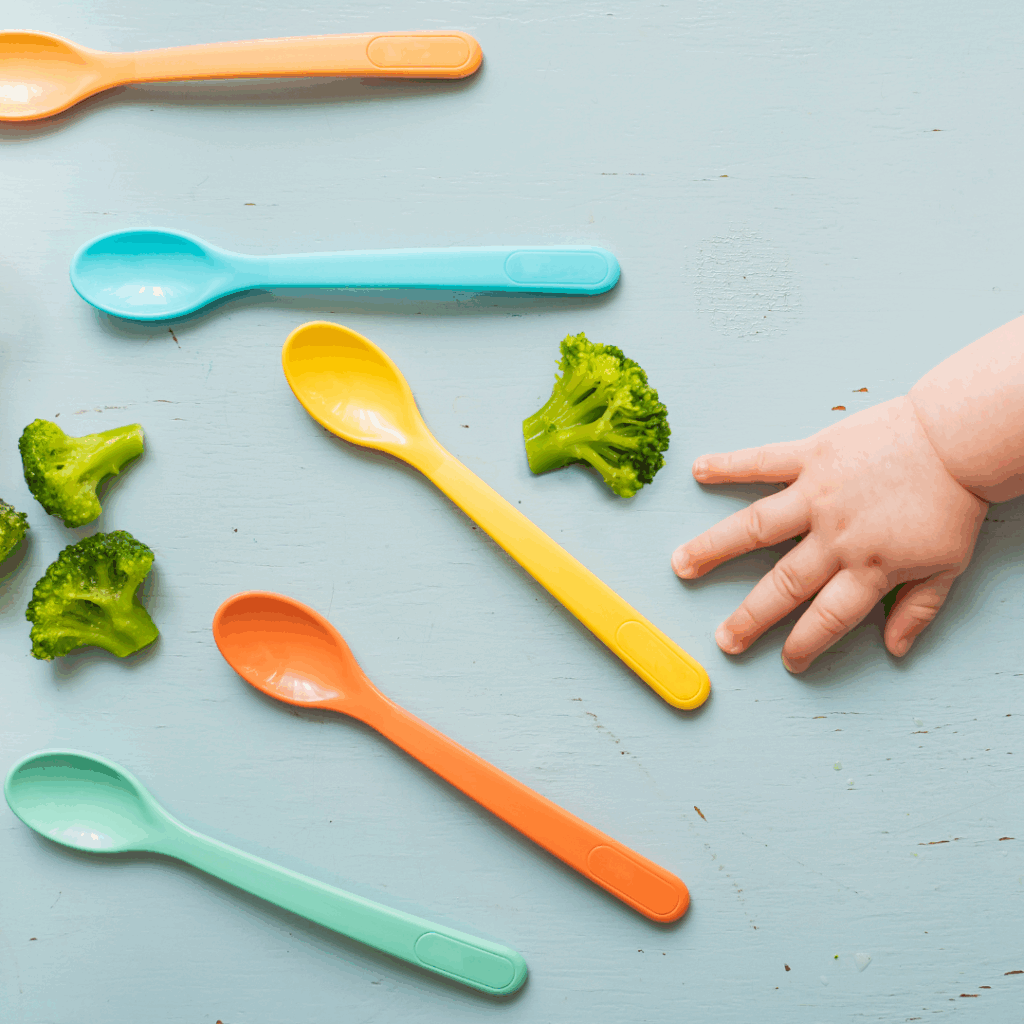 baby reaching for spoons