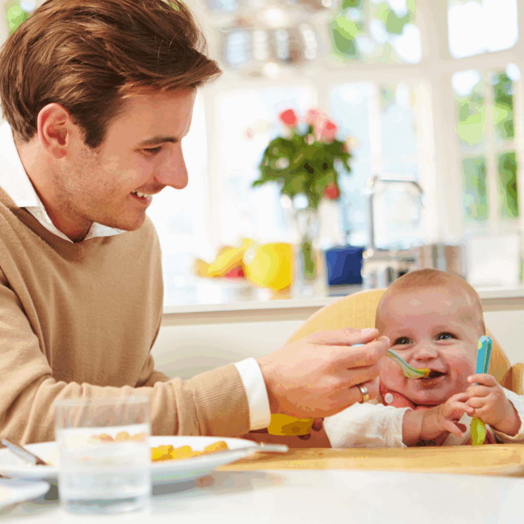 Dad feeding baby pureed food