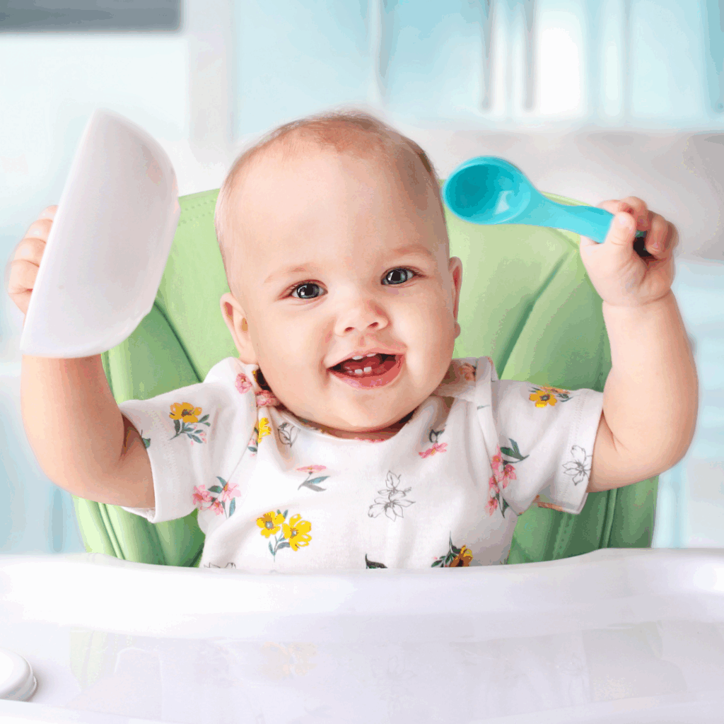 Baby with spoon and bowl