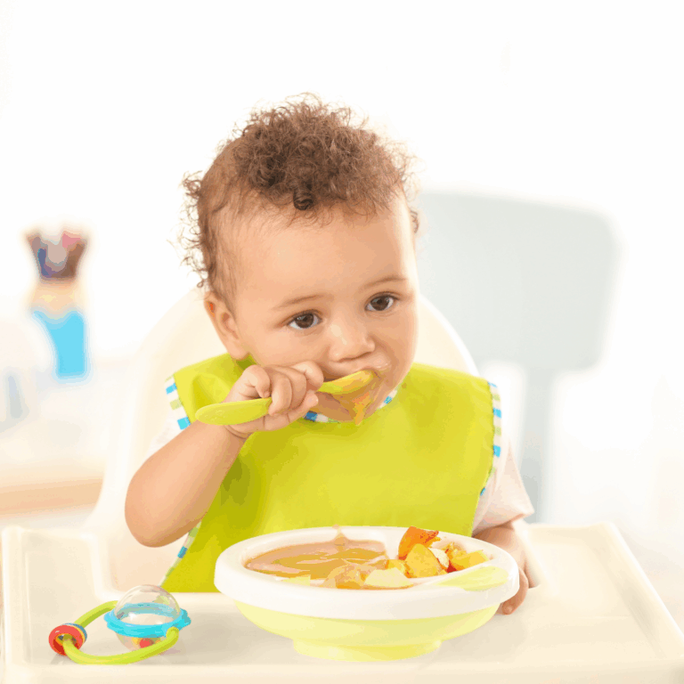 A baby eating solids served in wedge shapes for baby led weaning.