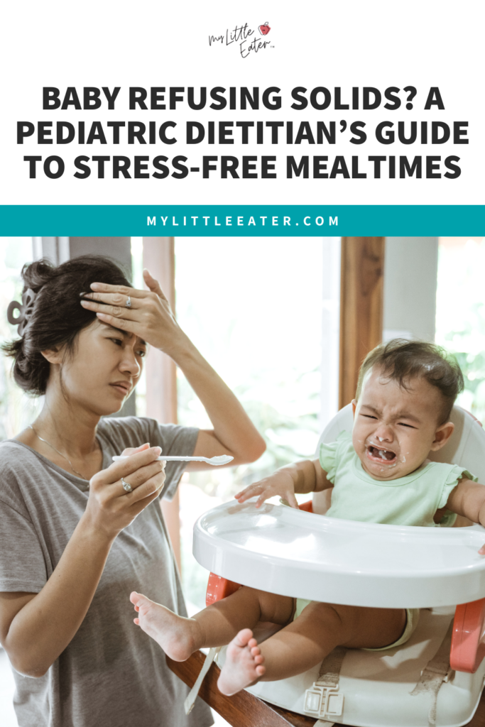 Baby crying in high chair with yogurt in his mouth; mom holding a spoon with hand on her head showing stress.